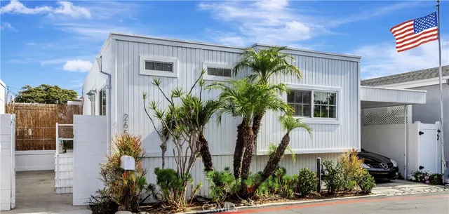 a front view of yellow house with a yard