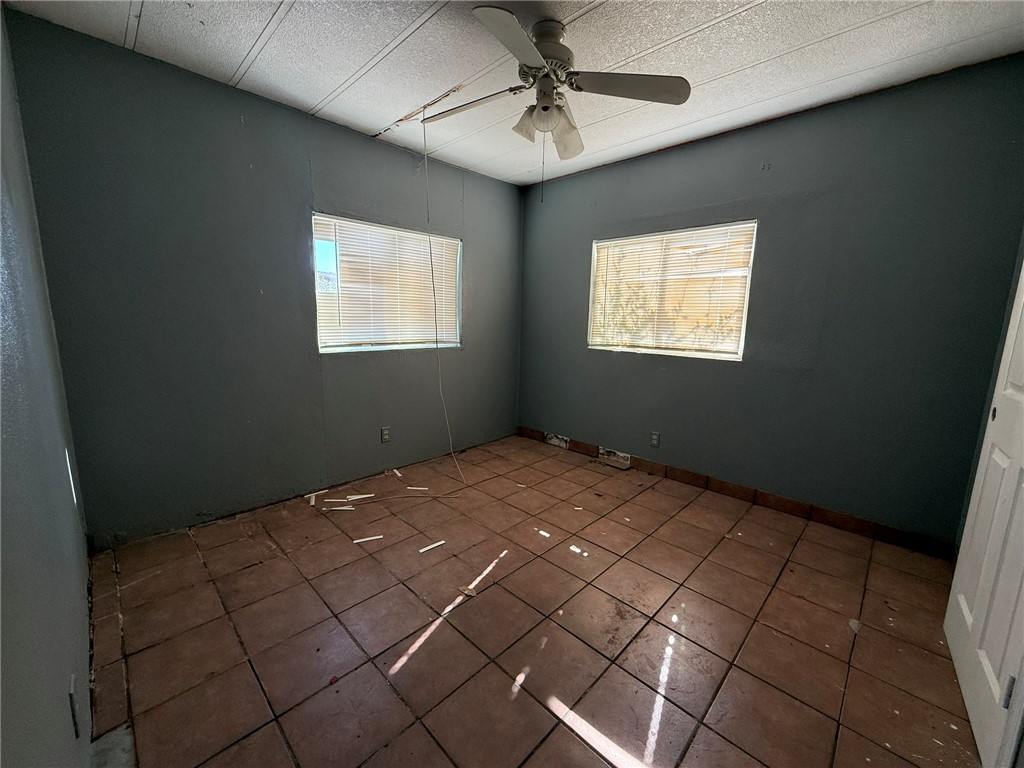 1629 Ramar Road Bullhead City, AZ 86442 - Photo 23 of 29 Tiled empty room featuring plenty of natural light and ceiling fan
