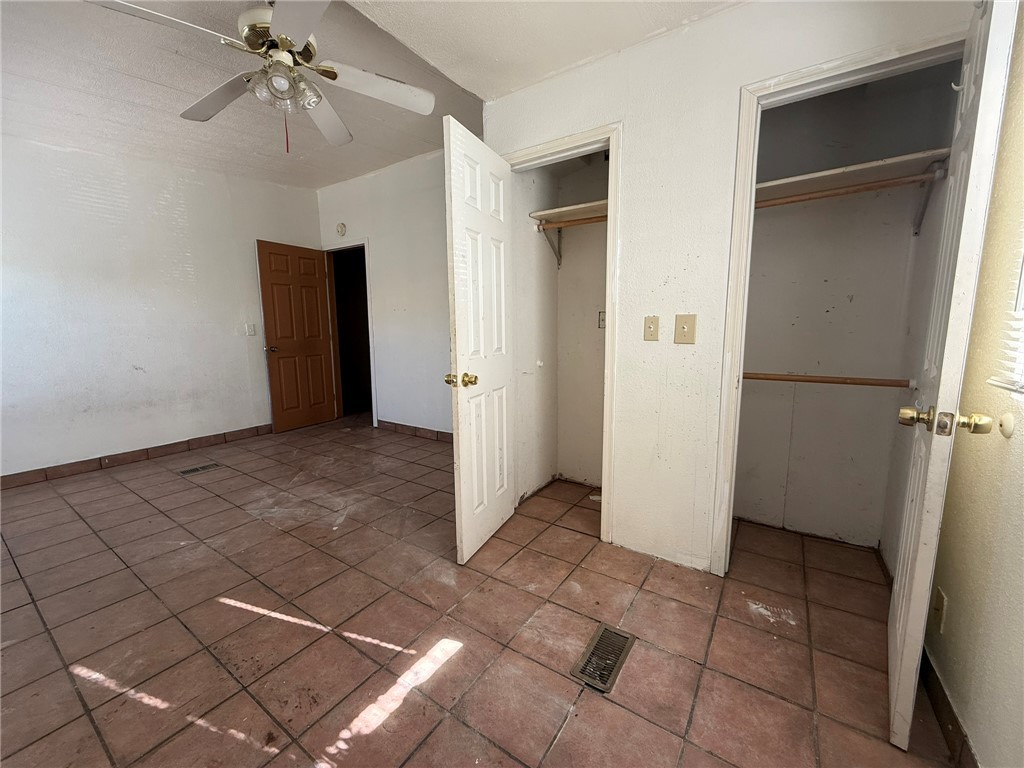 1629 Ramar Road Bullhead City, AZ 86442 - Photo 26 of 29 Unfurnished bedroom with two closets and ceiling fan