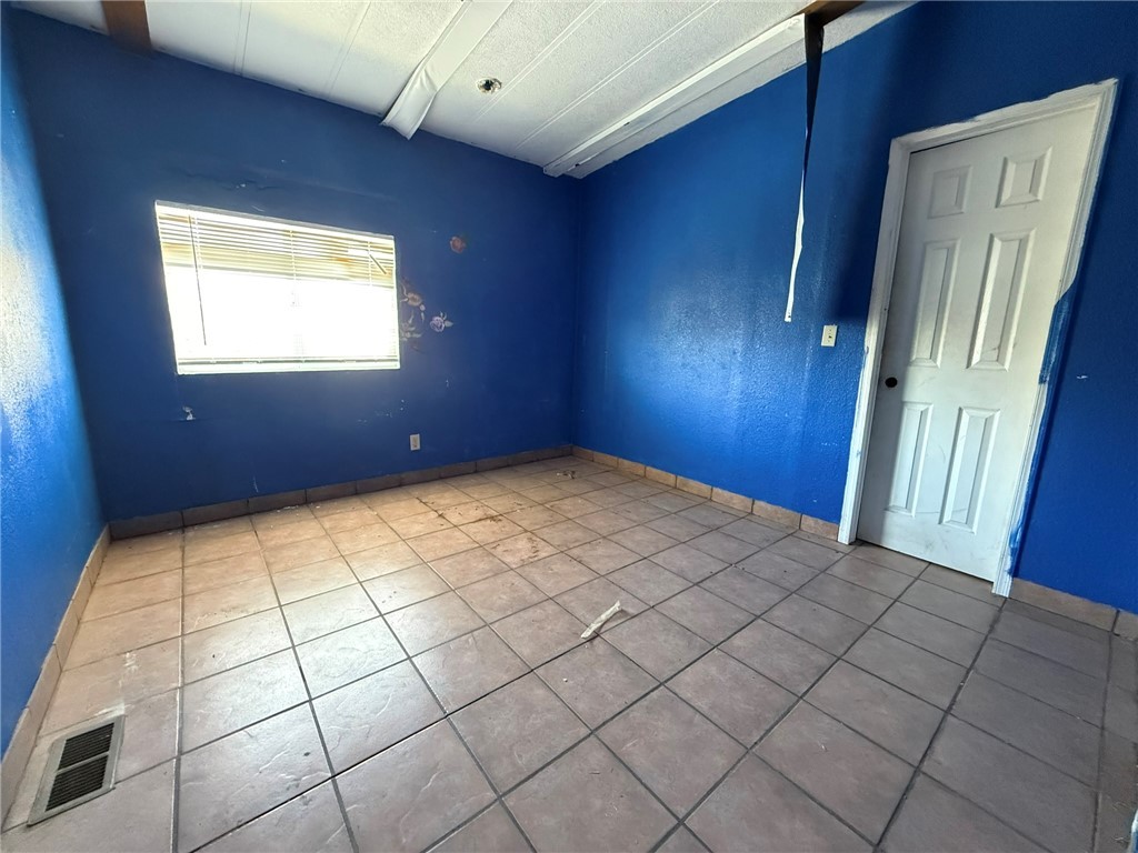 1629 Ramar Road Bullhead City, AZ 86442 - Photo 27 of 29 Spare room with tile patterned flooring and baseboards