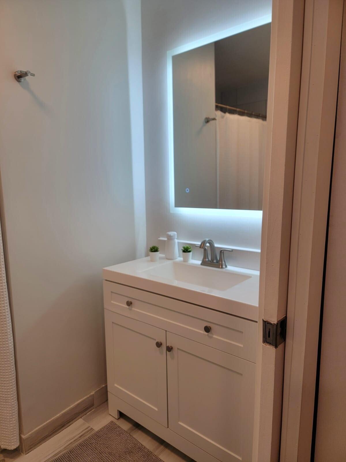 3209 Clint Moore Road, Unit 202 Boca Raton, FL 33496 - Photo 14 of 24 a bathroom with a sink and a mirror