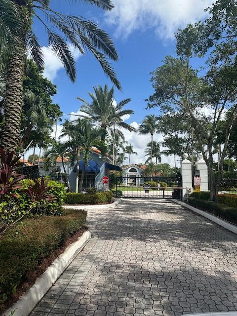 3209 Clint Moore Road, Unit 202 Boca Raton, FL 33496 - Photo 2 of 24 a city street lined with buildings and trees