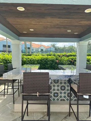 a view of an outdoor dining space with furniture