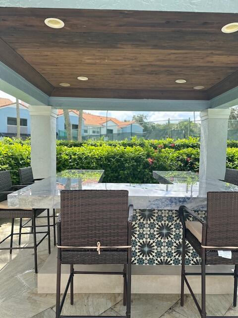 3209 Clint Moore Road, Unit 202 Boca Raton, FL 33496 - Photo 21 of 24 a view of an outdoor dining space with furniture