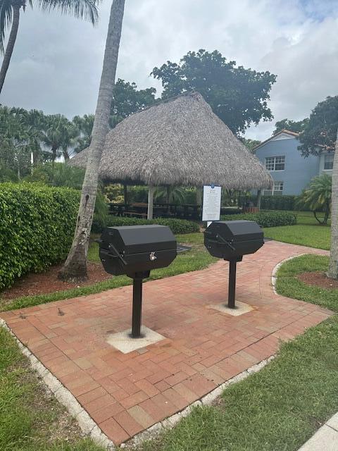 3209 Clint Moore Road, Unit 202 Boca Raton, FL 33496 - Photo 24 of 24 a front view of a house with garden
