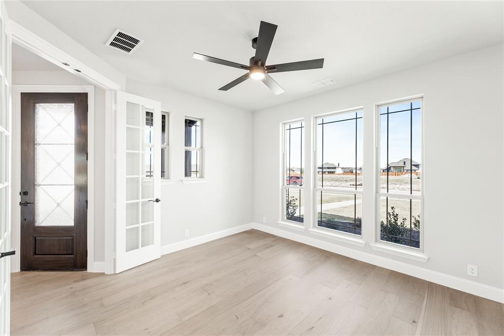 683 Crystal Lk Lane Red Oak, TX 75154 - Photo 7 of 39 wooden floor in an empty room with a window