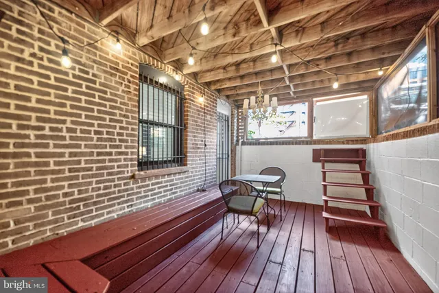 a view of a patio with wooden floor