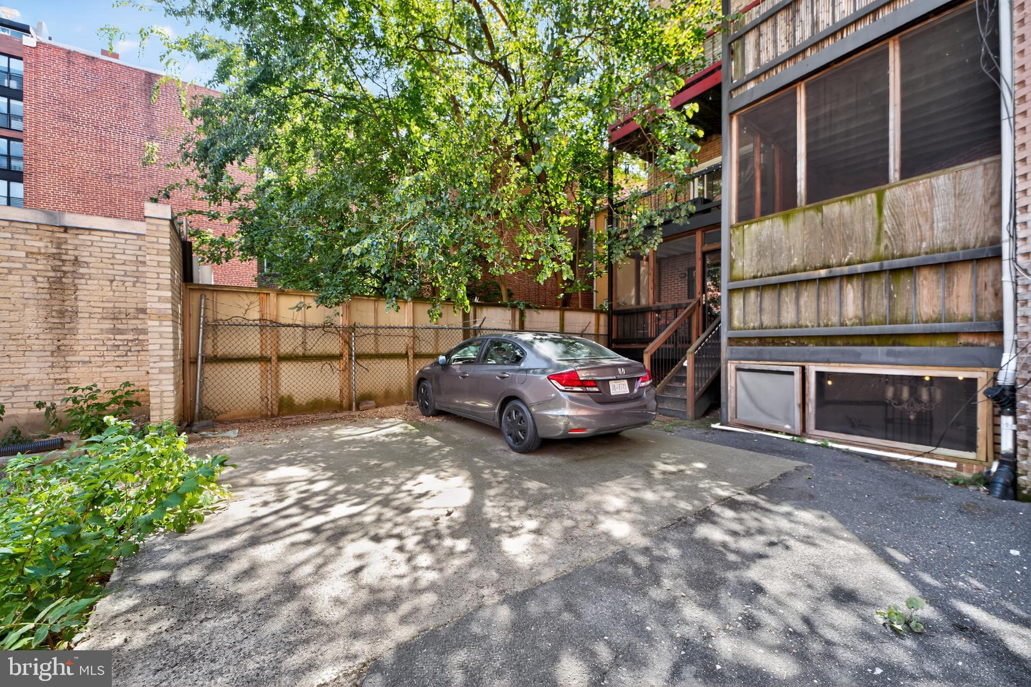 1421 T Street Northwest, Unit 2 Washington, DC 20009 - Photo 22 of 24 a backyard of a house with barbeque oven and outdoor seating
