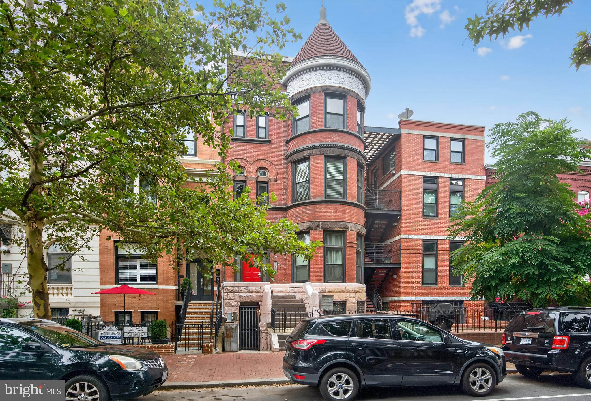 1421 T Street Northwest, Unit 2 Washington, DC 20009 - Photo 24 of 24 a front view of a building with lot of cars parked and a car parked in front of it
