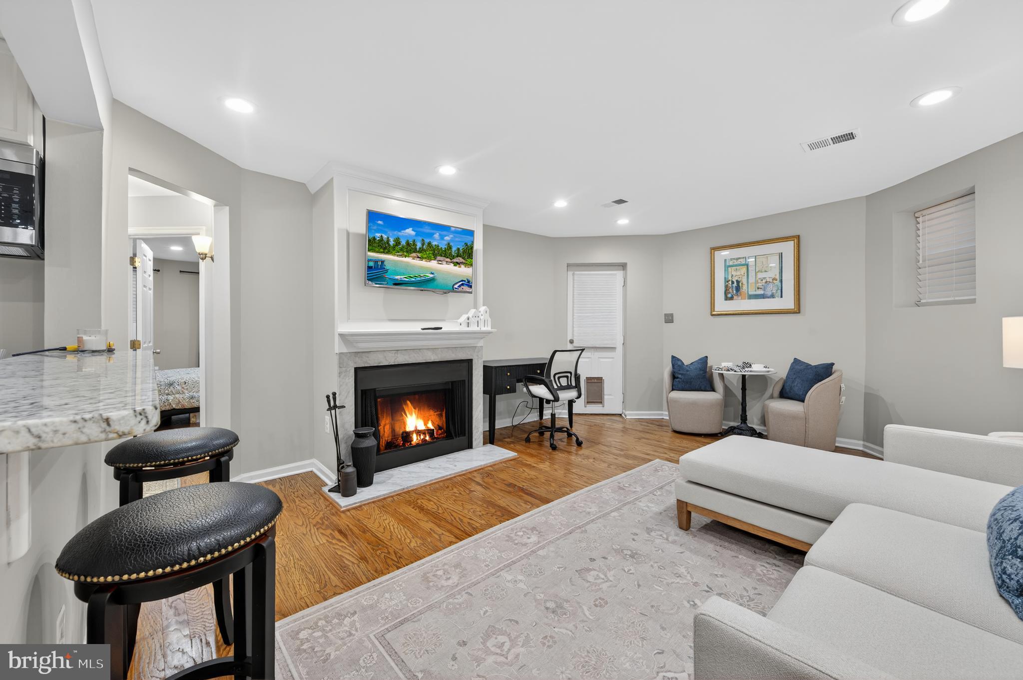 1421 T Street Northwest, Unit 2 Washington, DC 20009 - Photo 5 of 24 a living room with furniture and a fireplace