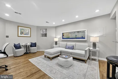 a living room with furniture and a lamp