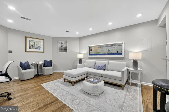 a living room with furniture and a lamp