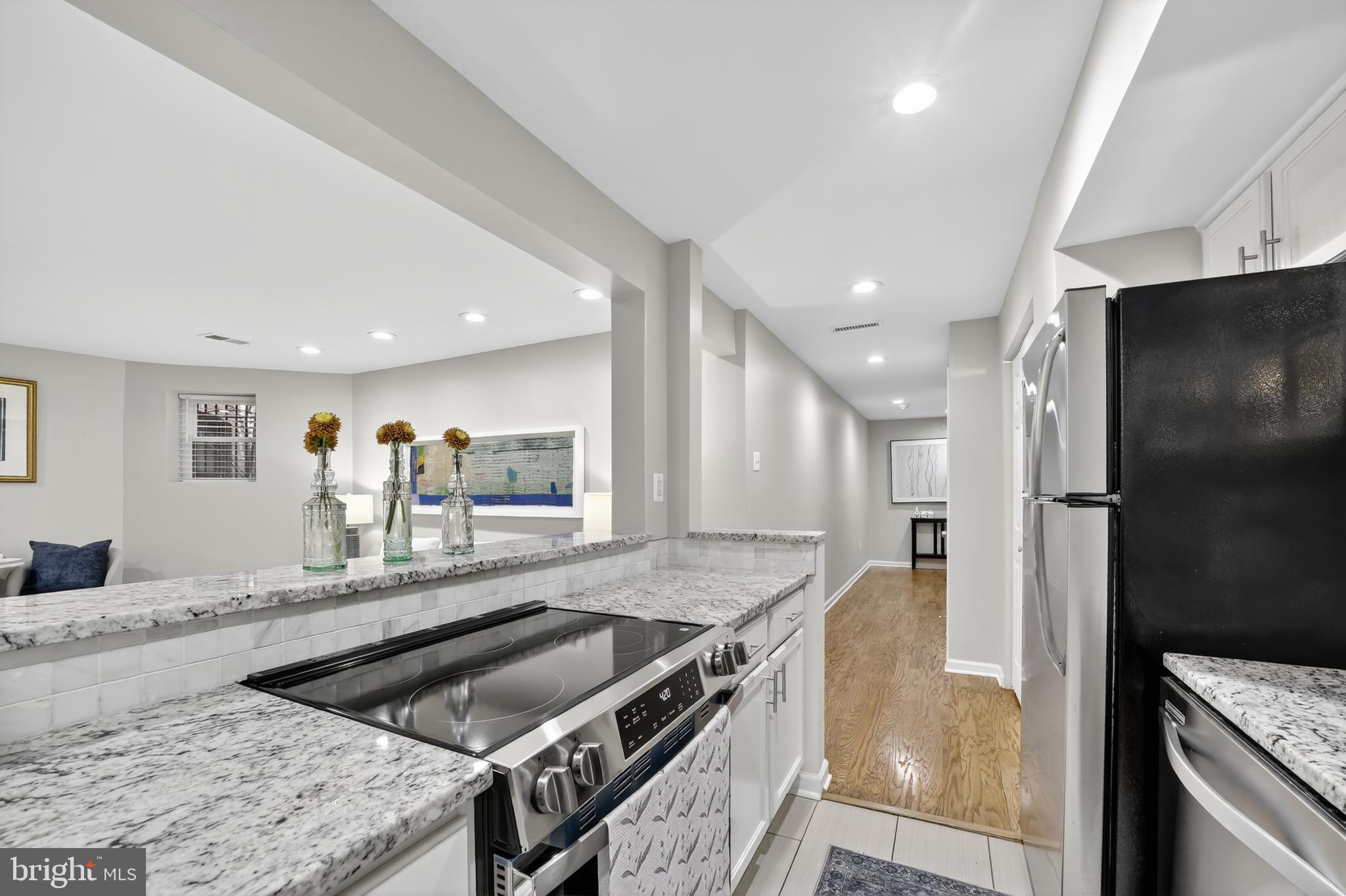 1421 T Street Northwest, Unit 2 Washington, DC 20009 - Photo 10 of 24 a kitchen with stainless steel appliances granite countertop a sink and a refrigerator