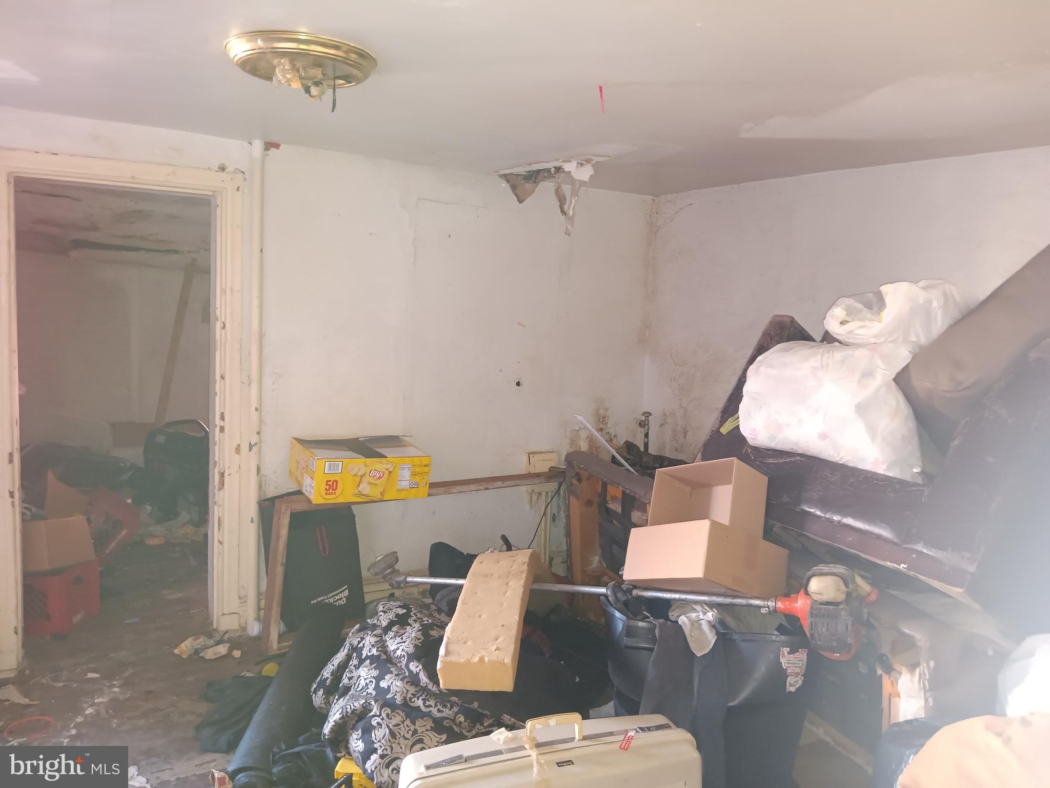 1302 North Spring Street Baltimore, MD 21213 - Photo 2 of 11 a living room with furniture and a table