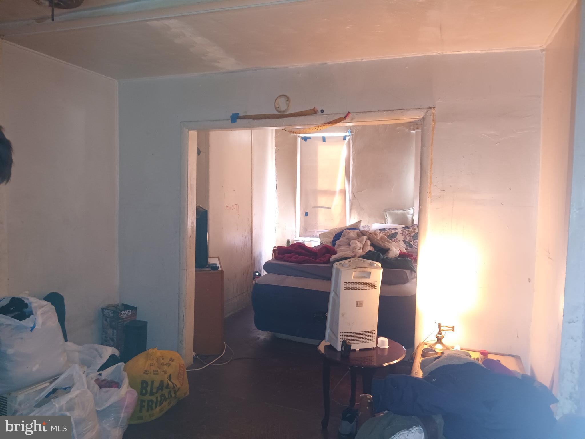 1302 North Spring Street Baltimore, MD 21213 - Photo 5 of 11 a bed room with a bed and a window