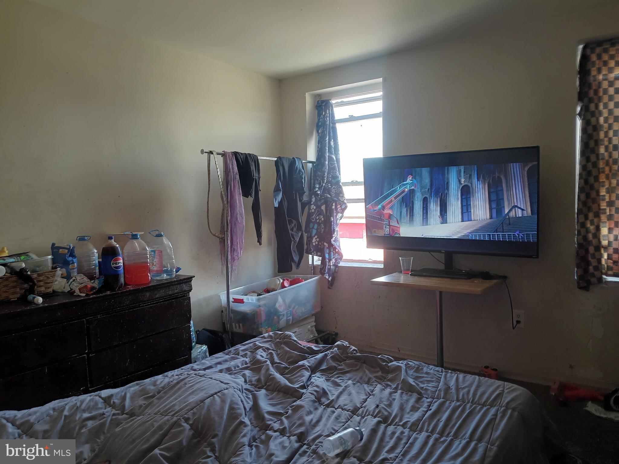 1302 North Spring Street Baltimore, MD 21213 - Photo 6 of 11 a bedroom with a bed and a window