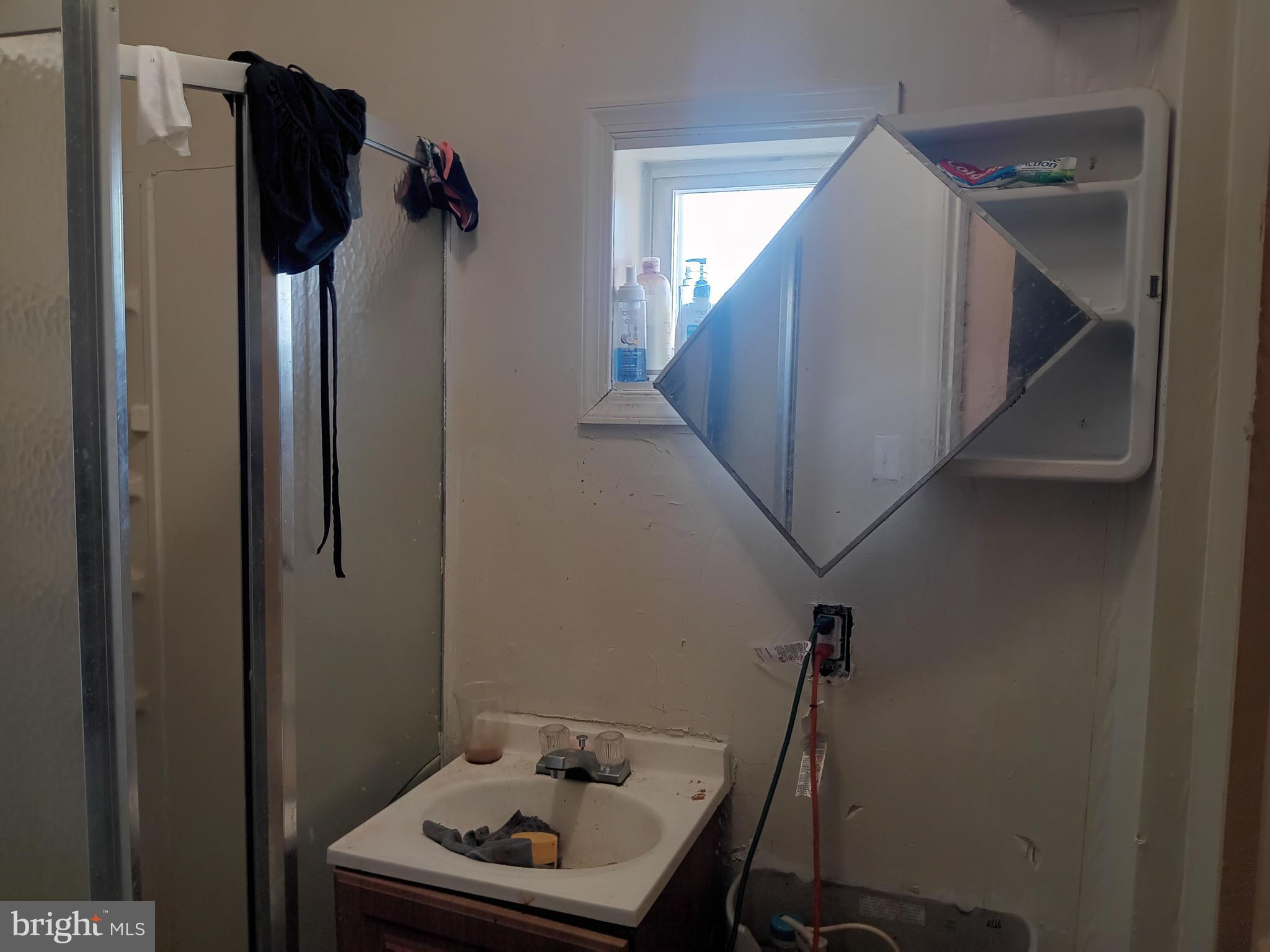 1302 North Spring Street Baltimore, MD 21213 - Photo 9 of 11 a bathroom with a sink and mirror
