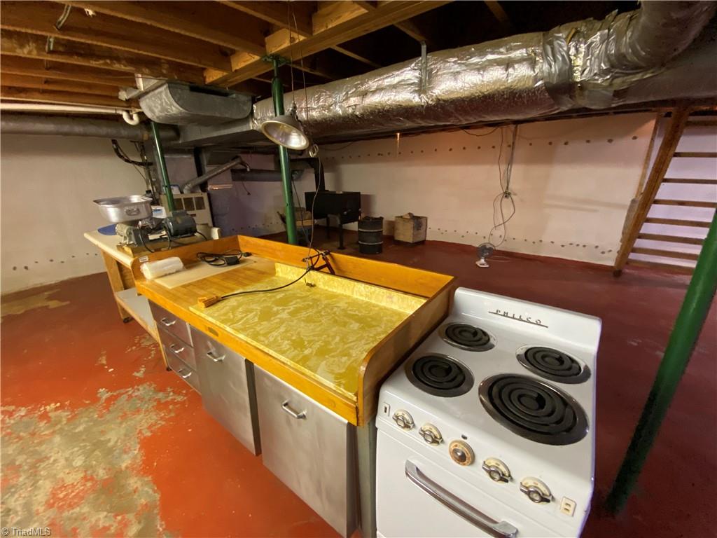 331 Collins Road Dobson, NC 27017 - Photo 50 of 50 Basement has a kitchen. Wood stove you can see in background