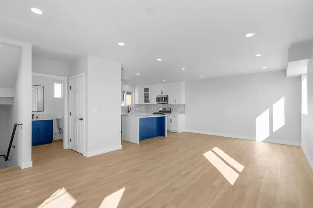 a view of a kitchen with wooden floor and a kitchen