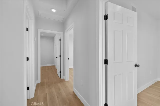 a view of a hallway with wooden floor