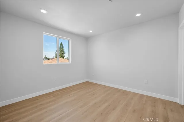 a view of room with wooden floor and window