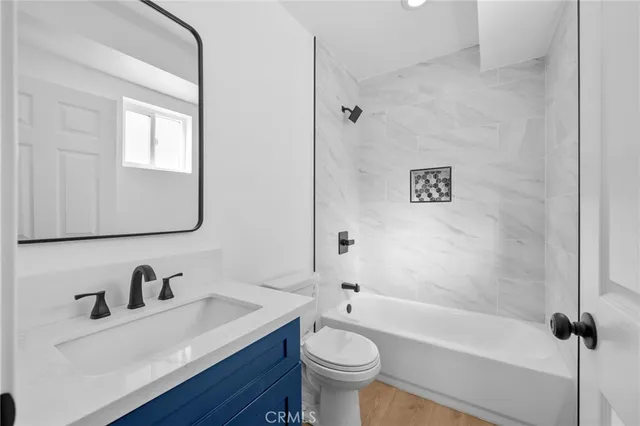 a bathroom with a sink vanity mirror and toilet