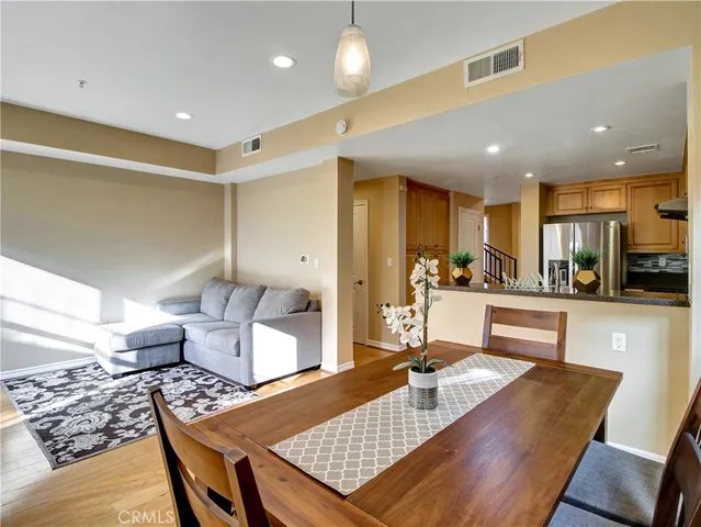 a living room with lots of furniture and kitchen view
