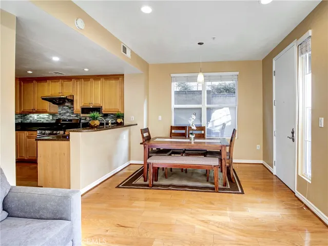 a living room with furniture a flat screen tv and a floor to ceiling window