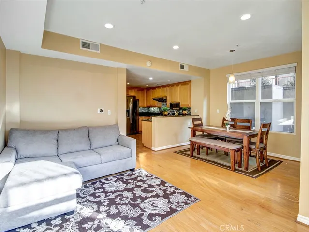 a living room with furniture and kitchen view