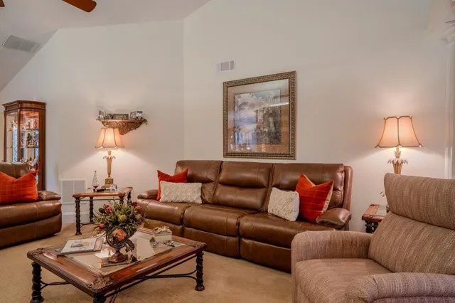 an aerial view of residential house with outdoor space and trees all around