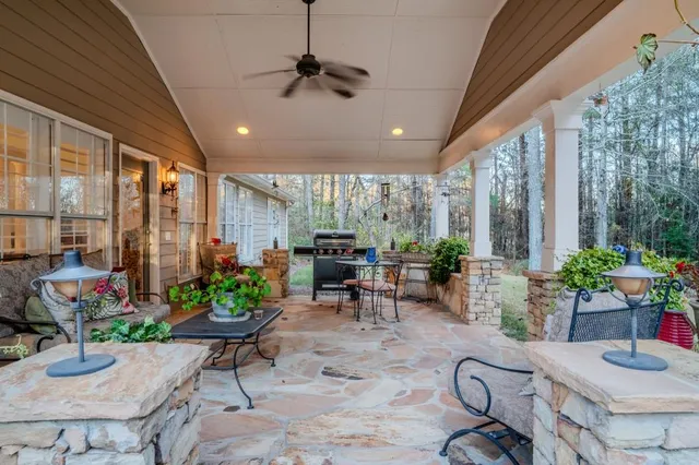 a dining room with furniture a chandelier and wooden floor