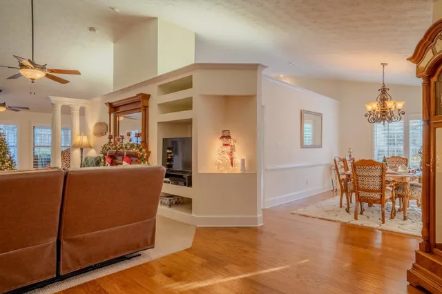 a kitchen with stainless steel appliances granite countertop a stove a refrigerator a kitchen island a dining table and chairs