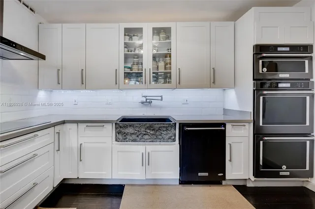 a kitchen with stainless steel appliances granite countertop a stove and a microwave
