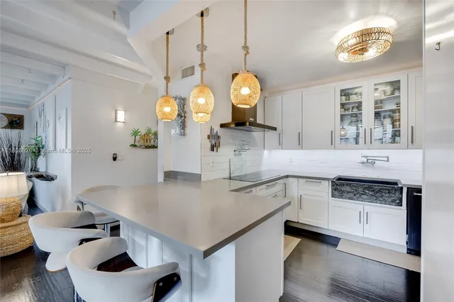 a kitchen with a table chairs and a stove top oven
