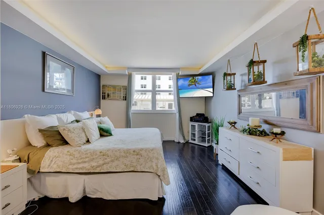 a bedroom with a bed and wooden furniture