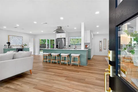a living room with furniture and kitchen view