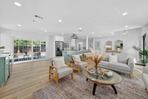 a dining room with furniture and wooden floor