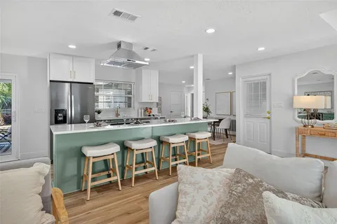 a dining room with furniture and wooden floor