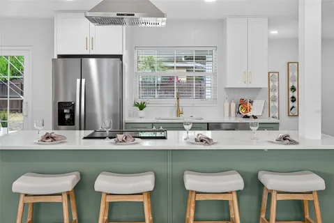 a view of a kitchen with cabinets and a wooden floor