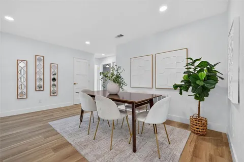 a bedroom with a large bed and a potted plant