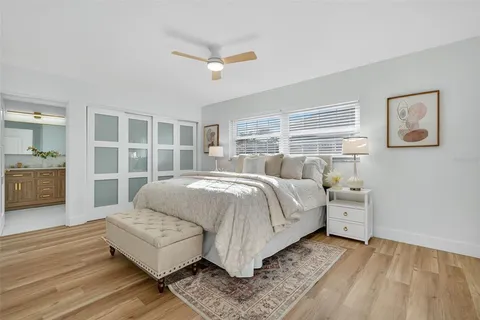 a bedroom with a bed and a large window