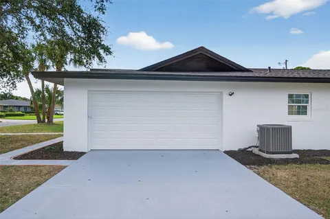 a backyard of a house with plants and trees