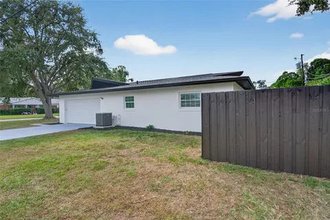 a view of a house with backyard and sitting area