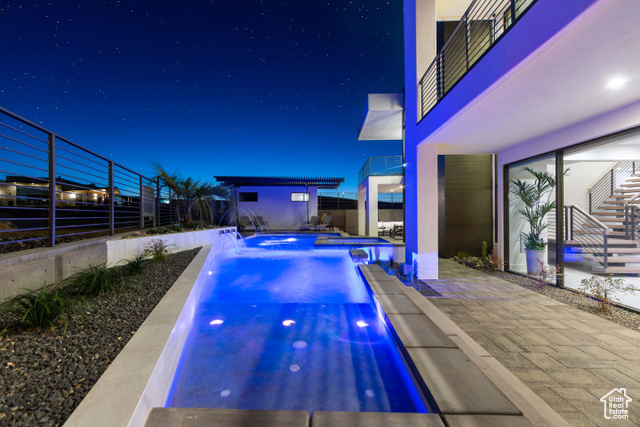 3558 South Cypress Road Hurricane, UT 84737 - Photo 43 of 57 Pool at night with a patio, a hot tub, and pool water feature