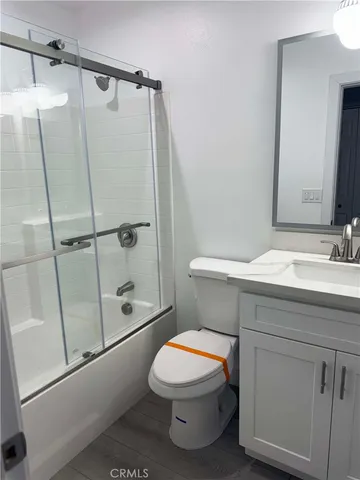 a white toilet sitting next to a bathroom sink