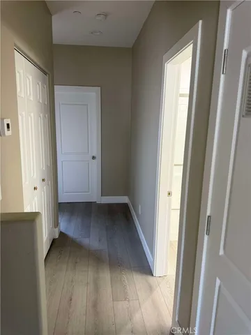 a view of a hallway with wooden floor