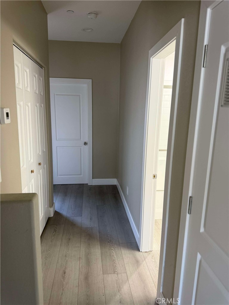 15909 Merrill Avenue, Unit 9 Fontana, CA 92335 - Photo 12 of 19 a view of a hallway with wooden floor
