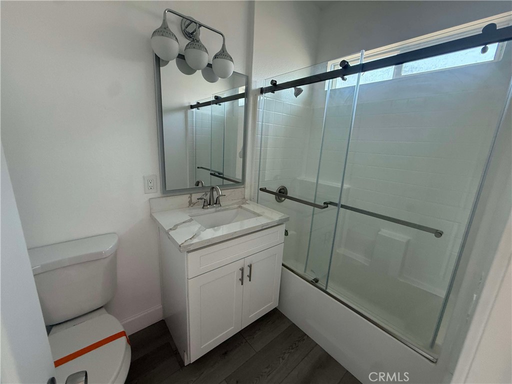 15909 Merrill Avenue, Unit 9 Fontana, CA 92335 - Photo 15 of 19 a bathroom with a granite countertop sink toilet and shower