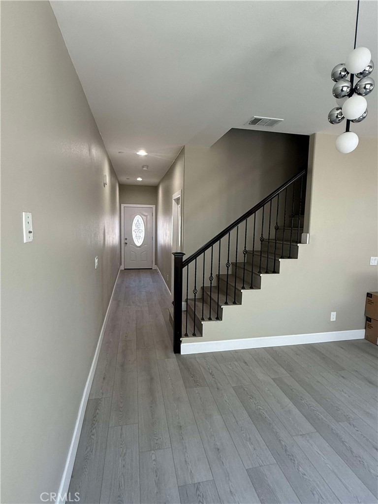 15909 Merrill Avenue, Unit 9 Fontana, CA 92335 - Photo 5 of 19 a view of entryway and hall with wooden floor