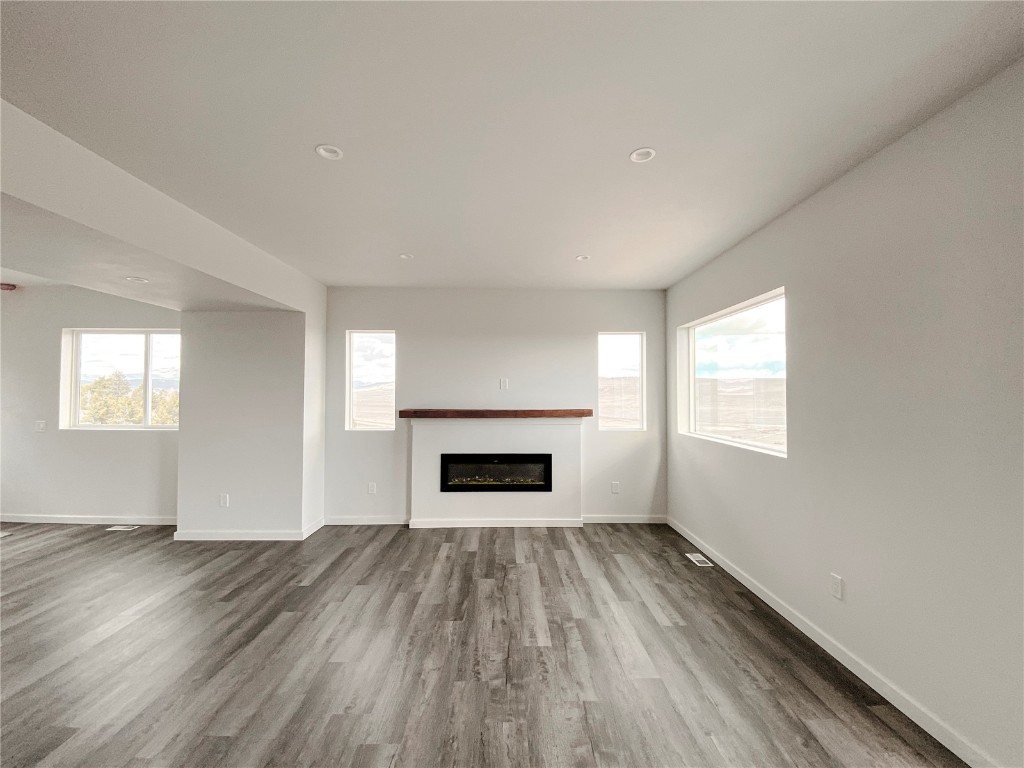 344 Redhill Road Fairplay, CO 80440 - Photo 14 of 34 an empty room with windows a fireplace